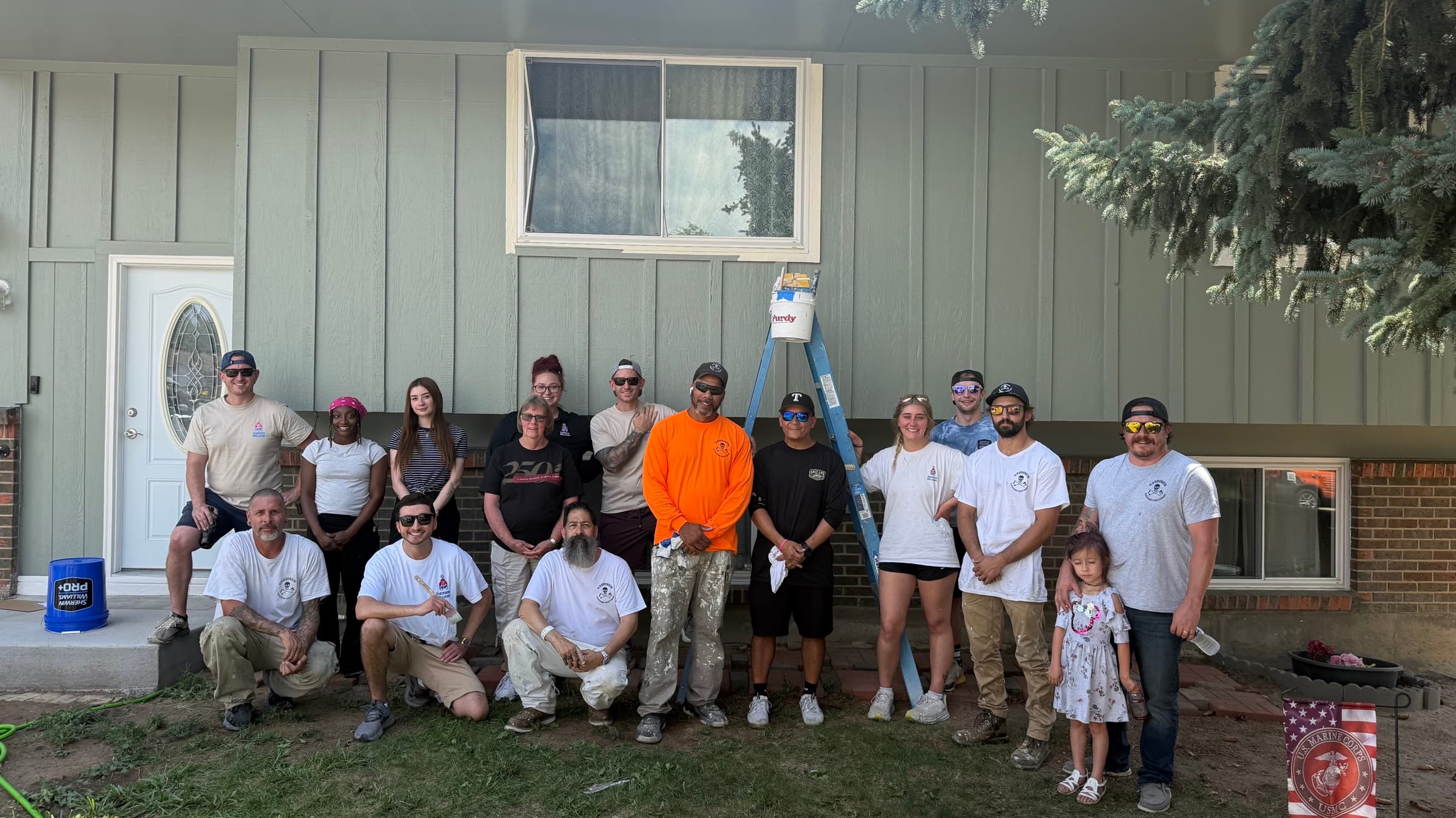 Gardiner crew and community members outside a completed veteran house-painting project