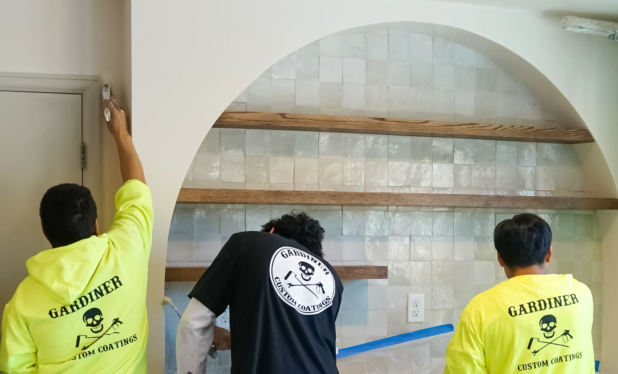 Three Gardiner painters working around a protected residential kitchen arch